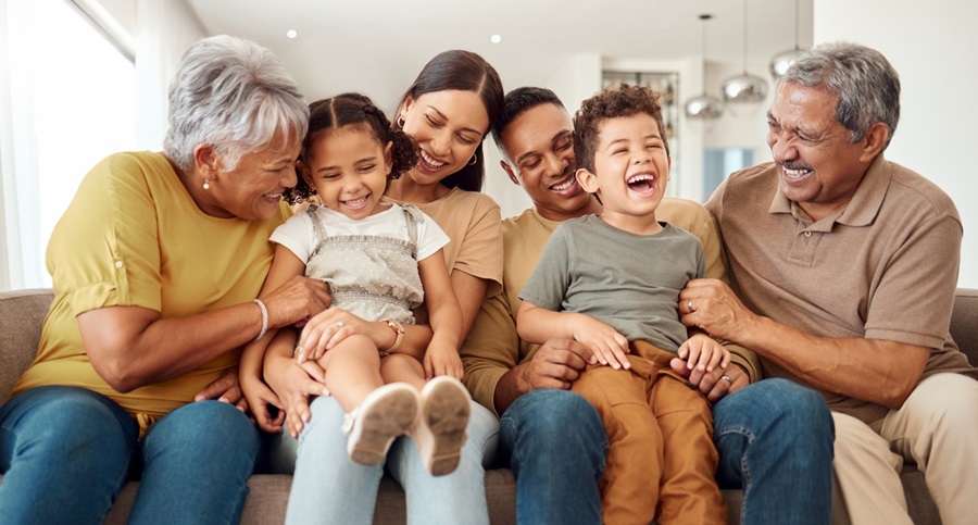 Extended family laughing on couch