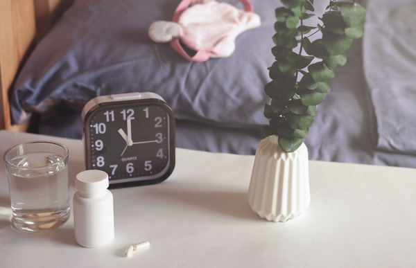 Bed, alarm clock and sleeping pills
